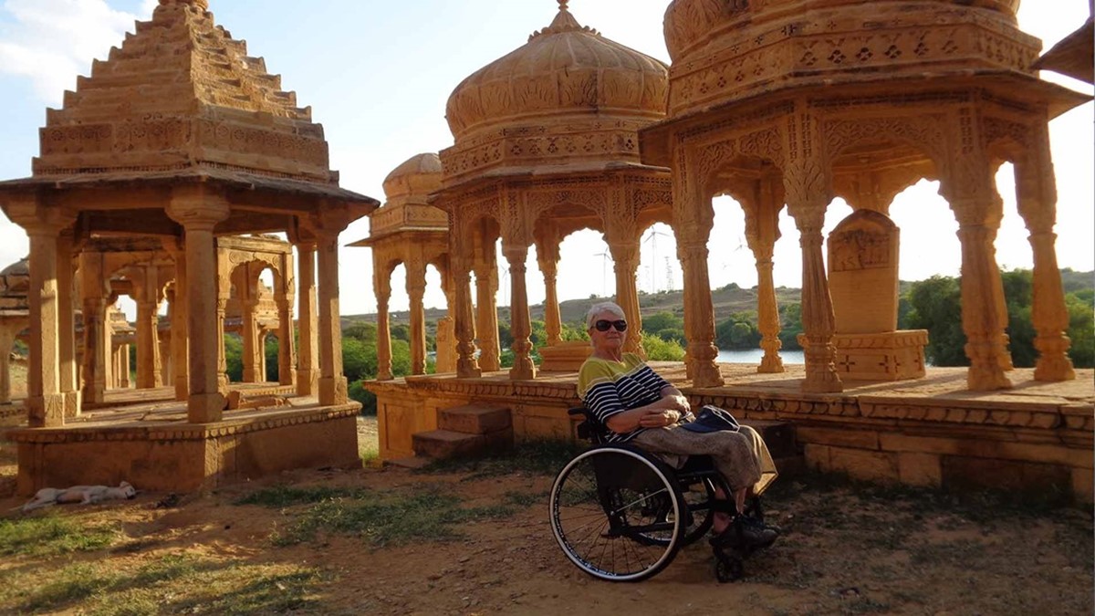 Jen Jarvis sits in front of ancient indian buildings