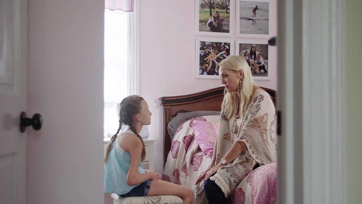 Ava speaking with her Mum in her bedroom.